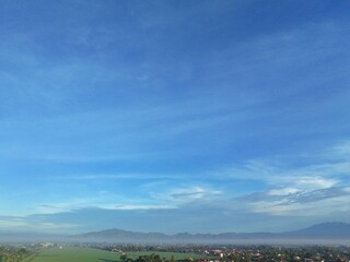 Beautiful blue sky with white clouds. The sky was clear and bright, and clouds were scattered all over the sky. The scene was peaceful and serene, as if the viewer was gazing at a beautiful day.