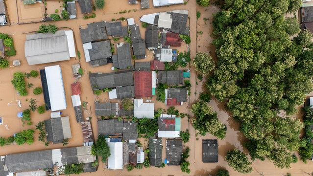 Aerial view of local house in suburb area in Chiang Rai downtown flooding by Kok river after typhoon Yagi has swept Southeast Asia.