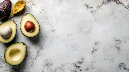 Fresh avocados cut and whole on marble surface