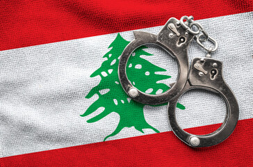 Flag of Lebanon and police handcuffs. Crime and offenses in country Concept
