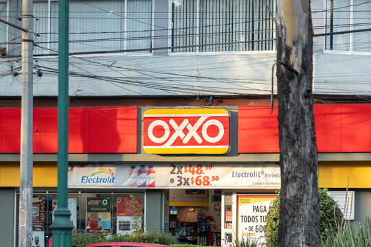 Mexico City, MEXICO - Dec 21 2024 : Front view of an OXXO convenience store with its sign and advertisements. OXXO is a Mexican convenience store chain with a widespread presence in Latin America.