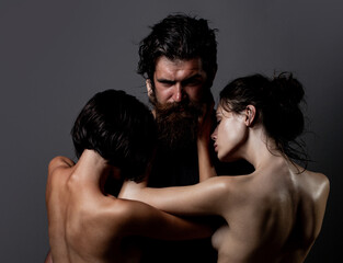 Sensual threesome kiss. Intimate relationship and sexual relations. Passion and sensual. Couple In Love. Romantic and love. Threesome concept. Three sexy models together. One man and two sexy women.