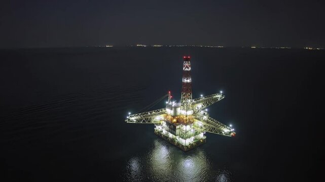 Illuminated offshore oil rig at night
