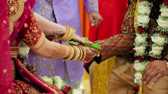  Indian Hindu Rituals that performed during the holy wedding ceremony. Bride and groom holding each others hands. Close up shot of part of wedding ceremony