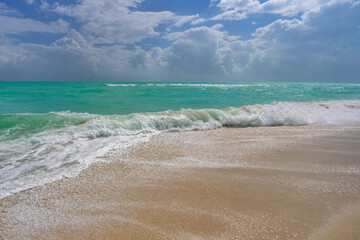 Ocean wave motion on sea shore. Summer sea breeze. Sea nature backdrop. Peaceful ocean. Dreamy ocean horizon. Coastal ocean paradise wallpaper. Seafoam waves. Azure water surface. Golden hour beach.