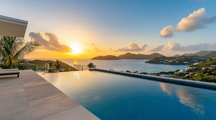 Fototapeta premium Luxurious villa infinity pool overlooking the caribbean sea at sunset