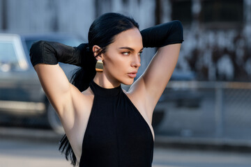 Portrait of Beautiful brunette woman posing on the street. Close-up woman portrait of young pretty...