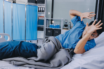 Lonely man silhouette sitting on the bed feeling depressed and stressed in the dark bedroom, Depression and anxiety disorder concept