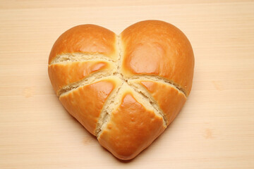 heart shaped loaf of bread on a wooden surface