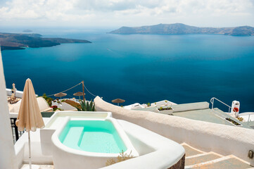 White architecture in Santorini island, Greece. Swimming pool with sea view.
