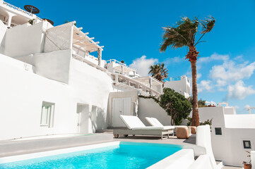 Luxury swimming pool with blue water in a hotel. Santorini island, Greece.