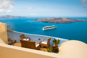Santorini island, Greece. Chairs on the terrace with sea view.