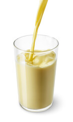 banana or vanilla milk pouring into glass isolated on white background