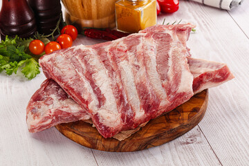 Raw pork ribs over board