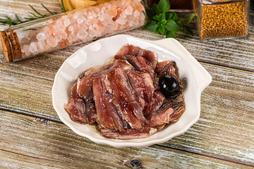 Canned anchovy with oil in the bowl