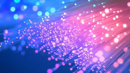 Abstract fiber optic cables glowing with blue and pink light creating a bokeh effect background