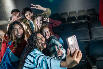 Young people taking selfie at movie theater or disco party