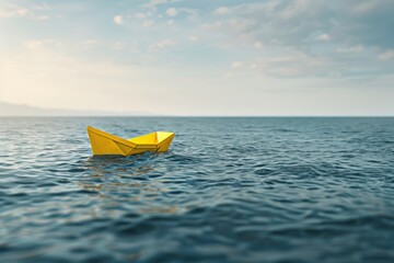 Bright yellow paper boat floats calmly on ocean waters under a serene sky at sunset