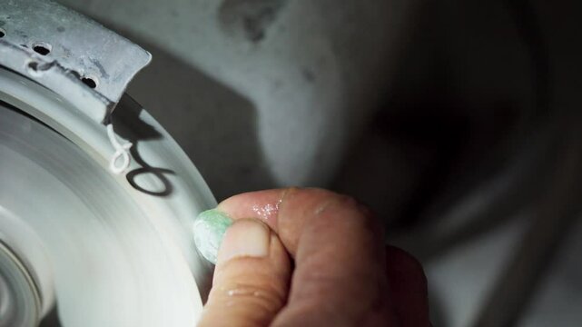 A skilled craftsman cuts jade for jewelry. Jade cutting process by an Asian craftsman