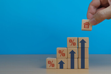 Asset Management Interest Rate, Hand Holding House Icon on Wooden Block with Percentage Icon
