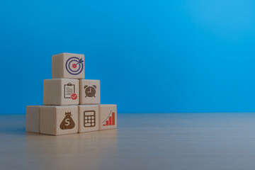 Financial goal management and investment growing on wooden blocks