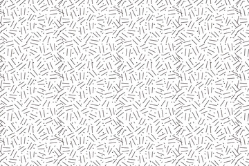 Abstract seamless pattern with randomly arranged short lines. Modern, minimalistic, and geometric texture for backgrounds and designs.