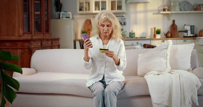 Elderly woman communicating with scammer by phone, lady feeling shock and crying . Data theft and security of finance, mature female retiree talking confidential data of credit card by phone, fraud