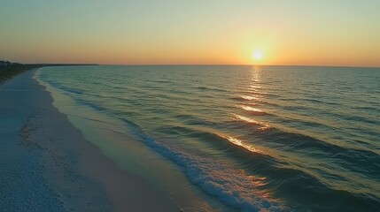 Golden sunset seascape illuminating serene shore and tranquil turquoise ocean