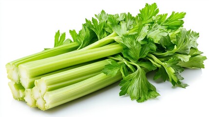 A bunch of fresh celery stalks with green leaves on a white surface in a studio setting for food photography