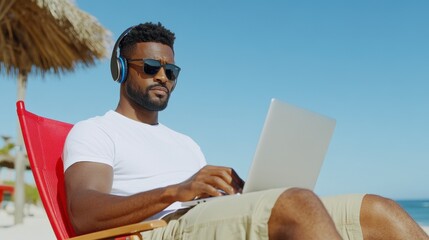 Remote Work Paradise: A man works remotely on a laptop while sitting in a lounge chair by the seashore. Amidst sunshine and blue skies, enjoying the perks of work-life balance.