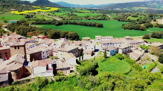 Aerial view of a picturesque spanish village surrounded by green fields