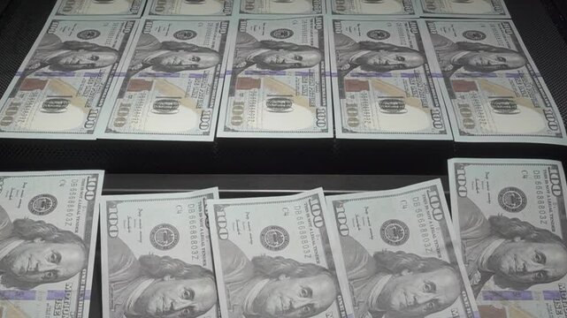 Many USD banknotes on conveyer belt. Money printing and production concept.