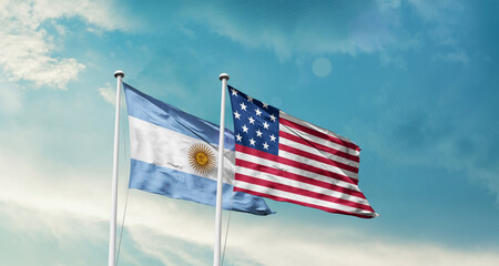 Argentina and America friendship flags are waving in the sky.Two country flag for agreement or deal. Argentina USA national flag for comittment.