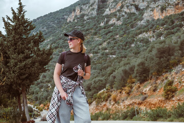 Travel,Young female traveler walking alone alongscenic mountain road solo travel, digital nomad...