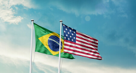 Brazil and America friendship flags are waving in the sky.Two country flag for agreement or deal. Brazil USA national flag for comittment.