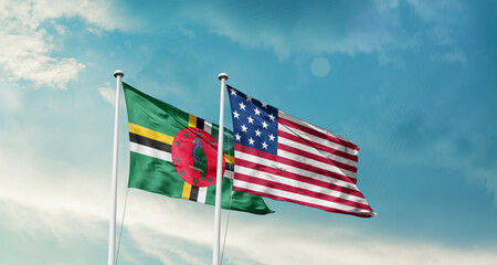 Dominica and America friendship flags are waving in the sky.Two country flag for agreement or deal. Dominica USA national flag for comittment.