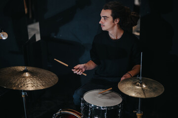 A talented drummer performing in a low-lit ambient environment, focused and immersed in music.