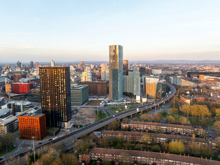 Obraz premium Aerial image of Mancunian Way at Hulme, Manchester with the city skyline at Sunset. 