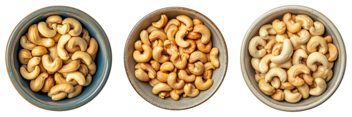 Three bowls overflowing with roasted cashews.