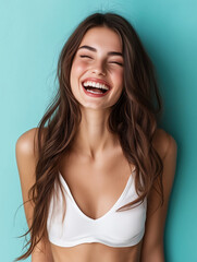 Young woman with long brown hair laughing with closed eyes