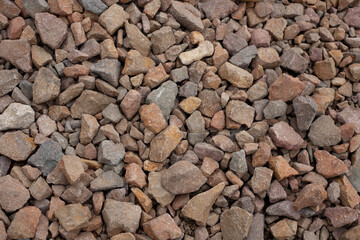 Close-up of porphyry aggregate, construction crushed stone. Natural building material, suitable for road construction, landscaping, and concrete production