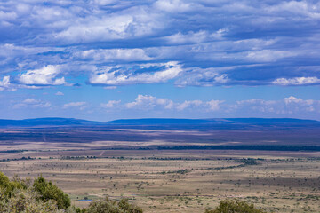 landscape with mountains and clouds Maasai Mara National Reserve is an area of preserved savannah wilderness in southwestern Kenya, along the Tanzanian border. Great Rift Valley Narok County Province