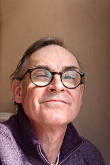 portrait of senior man with glasses smiling 