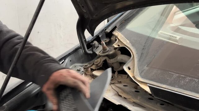 A technician is repairing the wheel section of a car
