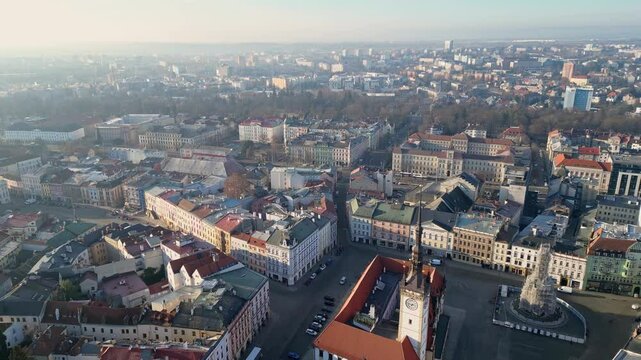 Olomouc, Czech Republic: Aerial backard footage of the ancient Olomouc town hall with the Astronomical Clock and the Church of St. Maurice in the old town in Czech Republic in a early morning light.