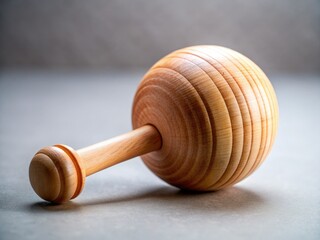 Close-up of a rustic wooden Knarre Ratsche; minimalist backdrop highlights its simple beauty.