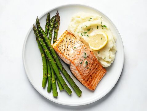 A beautifully plated salmon fillet with asparagus and mashed potatoes. Featuring elegance and gourmet flavors