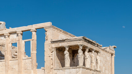 Obraz premium The Porch of the Caryatids in the Erechtheion on the Acropolis of Athens, Greece, with the moon in the background
