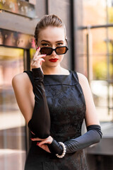 Young female model in black dress in Breakfast at Tiffany's style