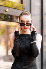 Young female model in black dress in Breakfast at Tiffany's style